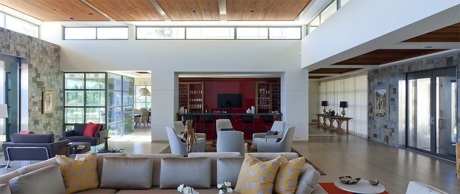 Black Residence great room with stone walls and wood ceiling