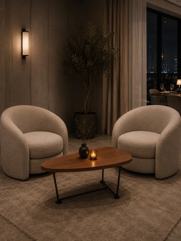 Pair of boucle swivel lounge chairs with walnut table