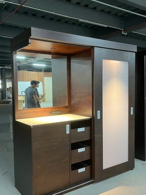 Walnut wall unit with sliding doors and lit vanity