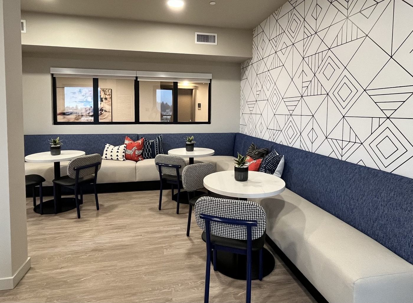 Cafe banquette seating with geometric wallpaper