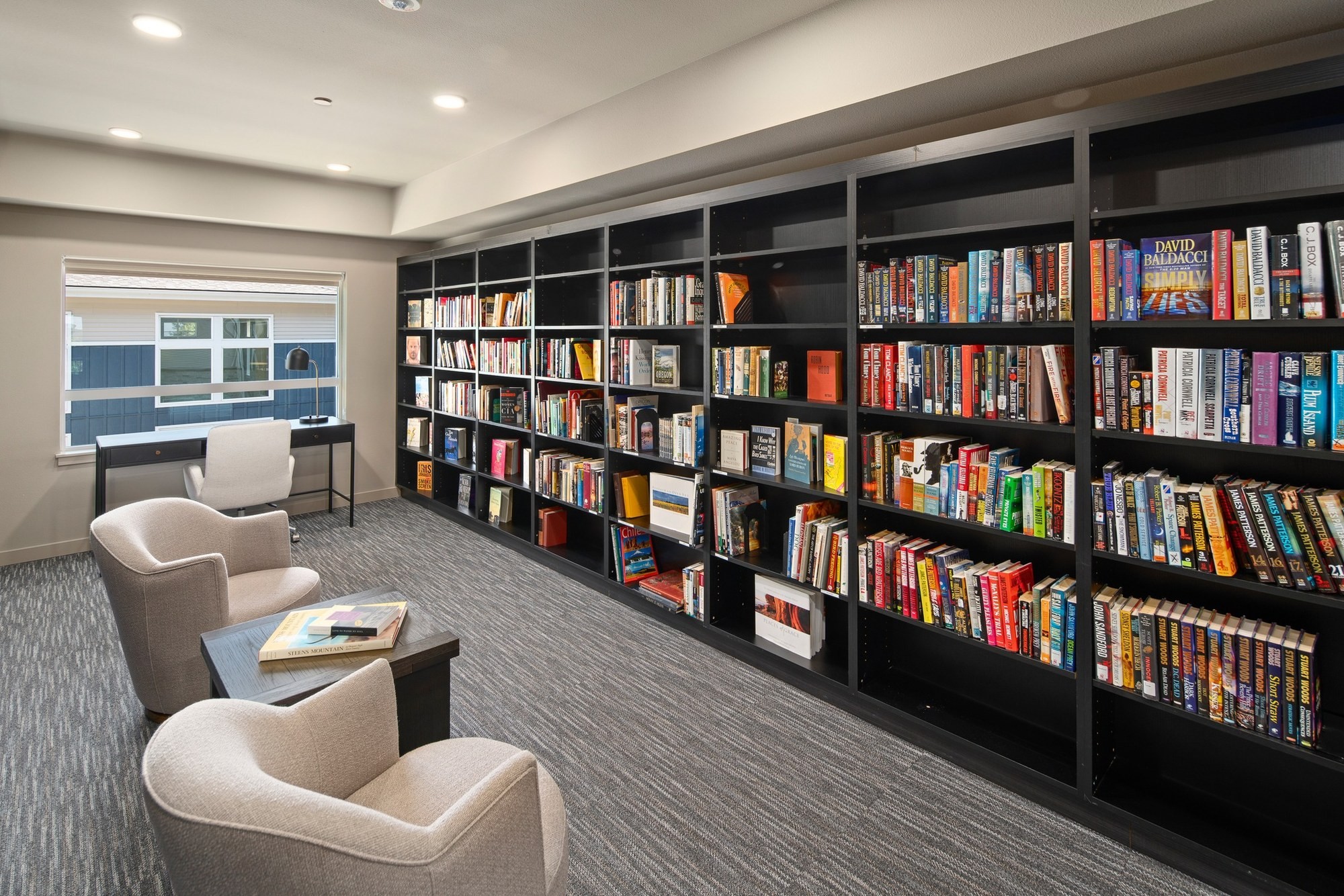 Resident library with built-in bookshelves and lounge seating