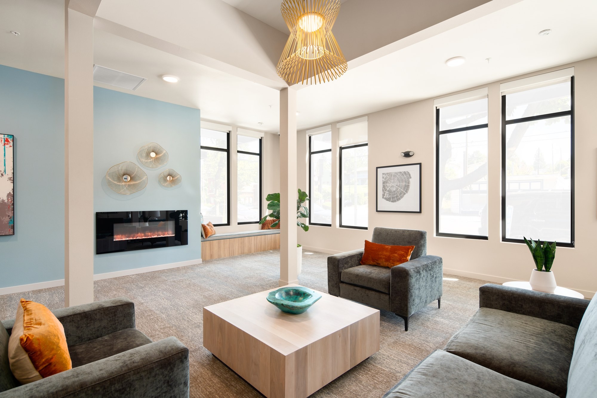 Resident lounge with velvet lounge chairs, fireplace, and custom coffee table