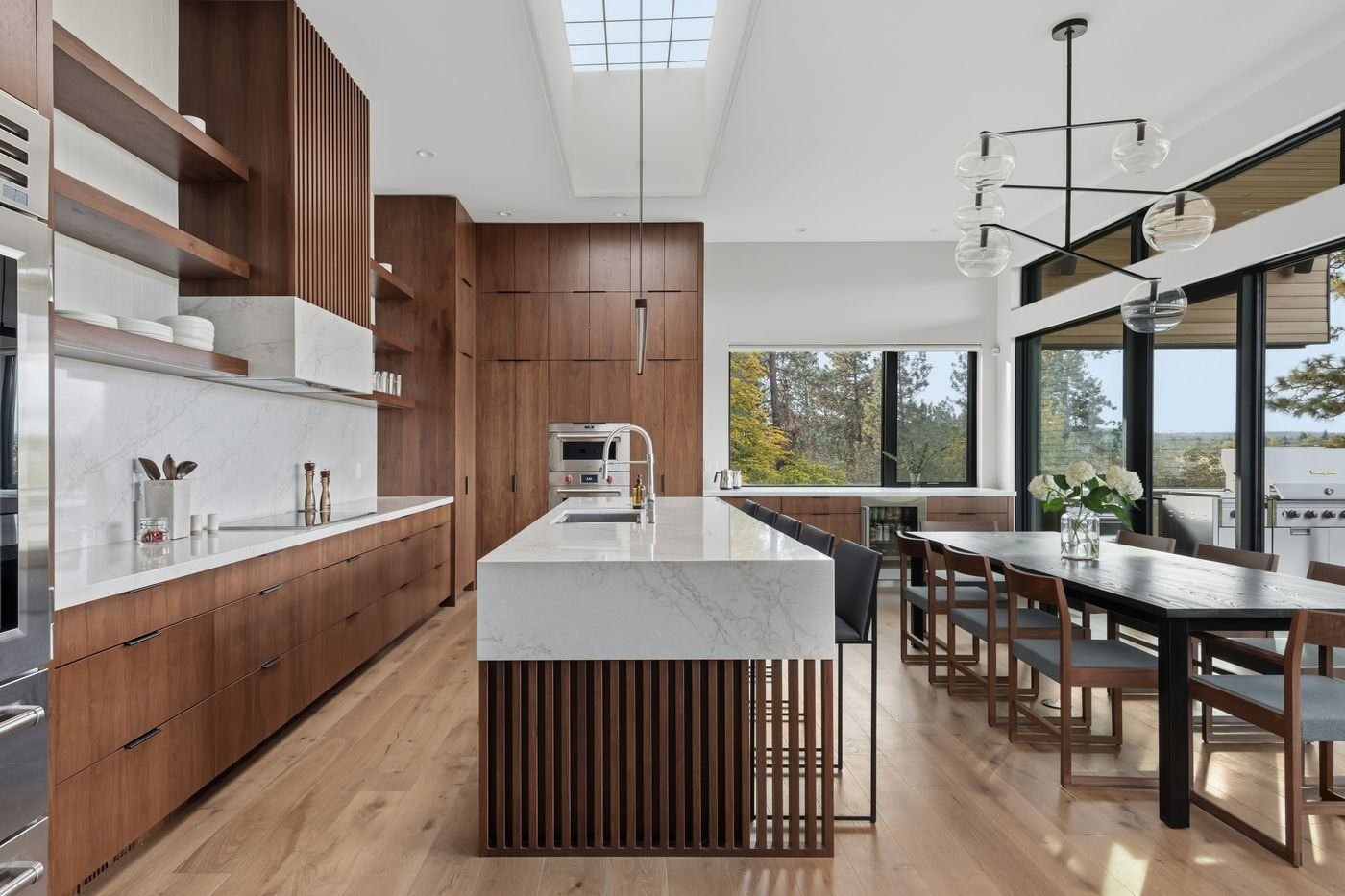 VanderWilde Residence walnut kitchen with fluted island and marble waterfall counters