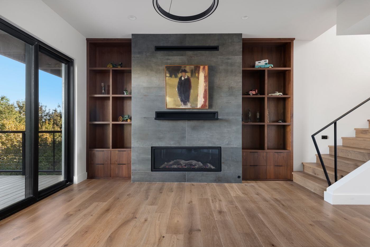 VanderWilde Residence great room with walnut built-in bookcases and steel fireplace